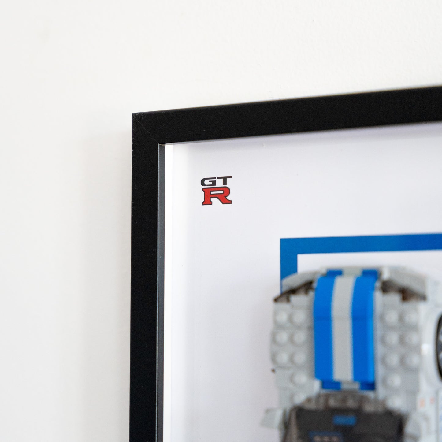 LEGO Speed Champions Nissan Skyline GT-R framed on the wall, angled view