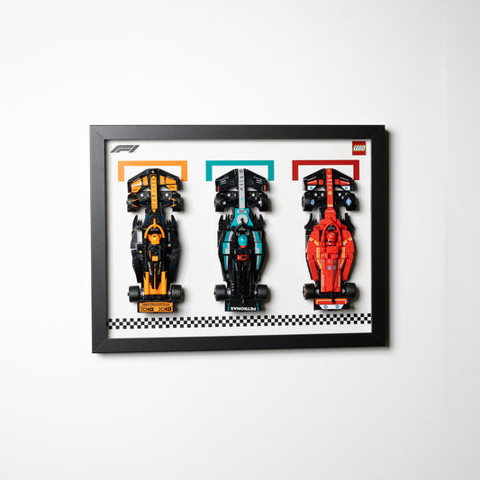 Three LEGO F1 Speed Champions cars in one wall-mounted display frame