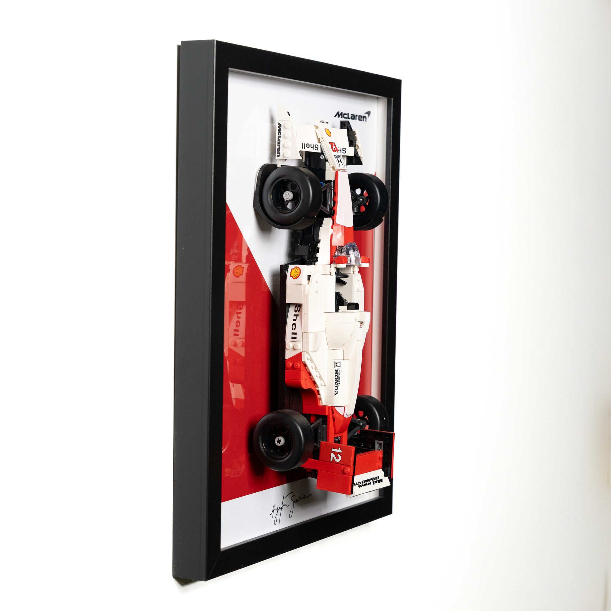 Front view of the LEGO Icons F1 display frame on a wall
